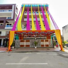 A full view of the house entrance decoration, showing how the fabric draping extends from the top of the building down to the gate structure, creating a complete festive look.