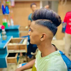 A side view of a high-volume pompadour with a skin fade. I focus on creating a smooth transition from the skin to the longer hair on top.