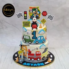 A unique dual-theme cake for a first birthday, combining a car theme with Minnie Mouse. This 7kg two-tier choco-chip cake is perfect for a grand celebration with diverse interests.