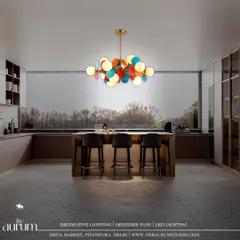 This large, multi-colored disc pendant brings timeless beauty and dazzling light to this modern kitchen. It serves as a vibrant, artistic centerpiece over the island, making the space feel both functional and fun.