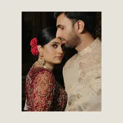 A soulful, artistic portrait of Uha and Ravi from their wedding at the Taj Falaknuma in Hyderabad, her red rose adding a touch of classic romance.