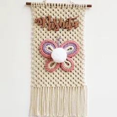 I made this special butterfly name hanging for my daughter's room. It features her name in a beautiful script, a colorful macrame butterfly, and a pompom center.