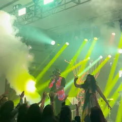 On stage in Ranchi, with a dancer and smoke effects, getting the crowd hyped. This shot captures the dynamic energy of a full stage production.