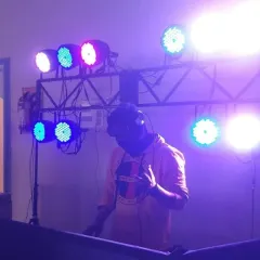 In the zone with my headphones on, surrounded by a professional lighting truss. This setup is perfect for larger venues where you need impactful lighting to fill the space.