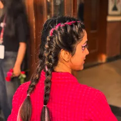It's not just about faces. Our festival hair glam, featuring colorful temporary braids and extensions, is a huge hit. This look adds an instant pop of fun and transforms your entire vibe in minutes.