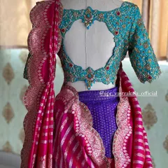 The back view of the turquoise and purple half saree set, highlighting the blouse's heart-shaped cutout.