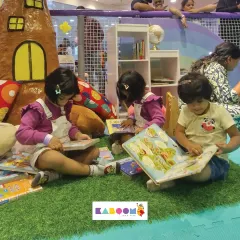 Story time! Our cozy reading corner is a great spot for kids to take a quiet break and explore the pages of a book.