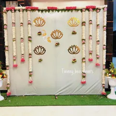 An elegant and simple backdrop perfect for an intimate home function. We used long garlands of fresh jasmine flowers (mallige hoovu) and accented the gray backdrop with golden lotus cutouts for a touch of grace.