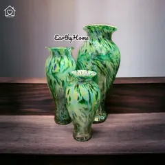 This set of three marbled green glass vases showcases expert craftsmanship. The swirling patterns evoke a sense of nature, making them a beautiful choice for floral arrangements or as standalone decor.