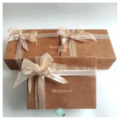 A beautiful suede box curated for a bridesmaid. The elegant packaging with a delicate ribbon hints at the pampering products inside, designed to make her feel cherished and appreciated.