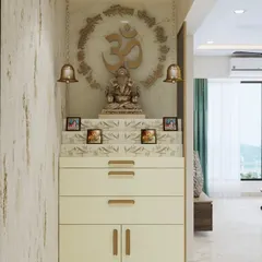 A compact and elegant mandir design, perfect for an apartment. It features a carved "Om" symbol, hanging bells, and a chest of drawers for storing prayer essentials.