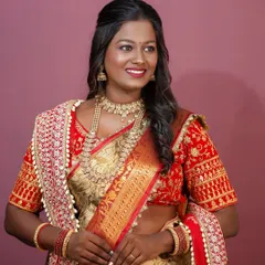The complete look, with a focus on how the rich colors of the saree and the gold jewelry complement her skin tone.