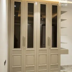This is what timeless elegance looks like. A custom wardrobe featuring classic paneling and tinted glass doors, built with durable HDHMR and finished to perfection. It’s not just storage; it’s a statement piece for your bedroom.