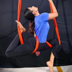 Aerial yoga is not just about flexibility, it's about finding balance and poise while suspended in air. This beautiful pose on the aerial hammock shows the artistry and control our adult students develop in their practice.
