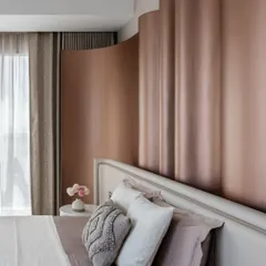 The master bedroom in 'The House of Arcs' features a fluid, curved headboard in a metallic finish, creating a soft, enveloping feel. This space is a perfect example of our approach to quiet luxury, where subtle textures and forms create a harmonious and restful environment.
