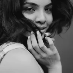 A close-up black and white portrait. I focused on creating flawless skin and defining the eyes with a soft liner to draw attention to the model's direct gaze.