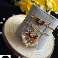 A beautiful lotus-themed Lumba and Rakhi set. The intricate enamel work and delicate pearl drops make this a truly elegant choice for your bhaiya and bhabhi.