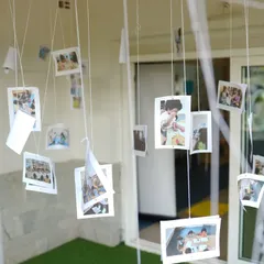 A beautiful display of photos hanging from the ceiling, showcasing the happy memories we create every day.