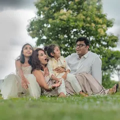 A candid, low-angle shot of a family looking up at the sky together. We love finding creative perspectives that show your family's connection and sense of wonder during an outdoor shoot.