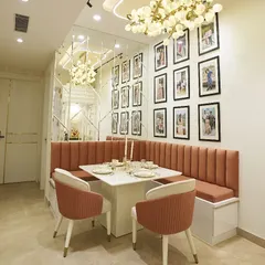 The full view of the dining nook, showcasing the modern chandelier and the mirrored wall that makes the space feel larger and brighter.
