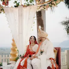 Seated together during the ceremony, this couple shares a look of love and happiness. The beautiful outdoor setting with a mountain view adds a grand scale to their intimate moment.