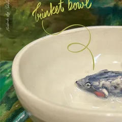 A tiny mouse finds a home in this handmade ceramic bowl. These pieces are perfect for holding everything from earrings to paper clips, adding a touch of handmade charm to any space.