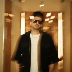 Styling Karan Kundrra in a cool, edgy look featuring a black jacket with leather details. This motion-blur shot captures the dynamic energy of the outfit.