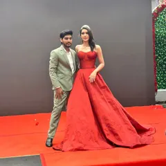 Posing on the red carpet with a model wearing one of my signature red ball gowns. This piece was designed for a fantasy Barbie theme, featuring a structured corset and a voluminous skirt for a true Hollywood feel.