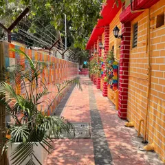 This narrow passageway at INS Tanaji was revitalized with vibrant paint, wall planters, and potted plants, turning a purely functional area into a colorful and pleasant walkway.