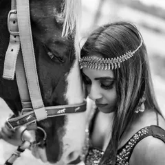 A powerful and intimate black and white portrait with a horse. This shot focuses on the connection and trust between the subject and the animal, creating a deeply emotional image.