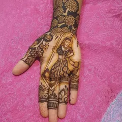 A full-palm design featuring a woman holding a dandiya stick, perfect for Navratri celebrations. The wrist is adorned with a dense floral pattern.