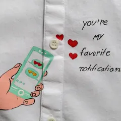 A close-up of a custom shirt detail. This "You're my favorite notification" design is a modern and cute way to show your love, perfect for a long-distance relationship gift.