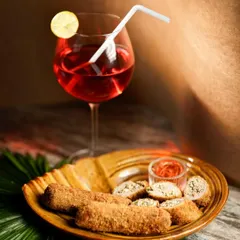The Chicken Swiss Rolls are paired with a refreshing red drink, making for a perfect appetizer and beverage combination for any party.