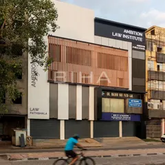 This view captures the Ambition Law Institute within its bustling urban environment. The renovated facade makes a bold statement, leaving a lasting impression that reflects the institution's professional ideology.