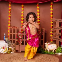 This little Krishna is caught in the act, playfully eating makhan in our festive Gokul-themed set.