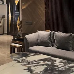 We believe luxury is found in the details. This composition from a Juhu apartment highlights a custom marble coffee table, the rich texture of the sofa, and a bespoke geometric door, demonstrating our commitment to curated, high-quality finishes.