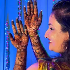 A candid shot of a bride admiring her intricate mehendi. The deep stain from my organic henna is clearly visible, ensuring a beautiful look for her wedding photos.