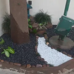 A small corner transformed into a tranquil zen garden. I used a mix of black and white pebbles, rocks, and a few select plants to create a low-maintenance decorative landscape.