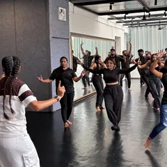 This is a typical moment in my class where I'm breaking down a new step for everyone. I make sure to guide the entire group so no one is left behind. The focus is on learning together and enjoying the process.