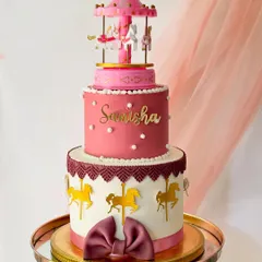 For a grand celebration, I created this three-tiered carousel cake. It features intricate lace piping, golden horse silhouettes, and a functioning miniature carousel on top, combining classic elegance with a touch of whimsy.
