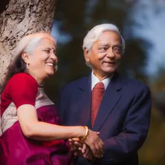 A beautiful, candid moment of connection. Their shared laughter and gentle handhold during their 50th-anniversary photoshoot tell a story of a long and happy life together.