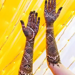Full bridal henna from fingertips to elbow. This design features a mix of traditional patterns, netting, and bold floral work, all created with my organic henna.