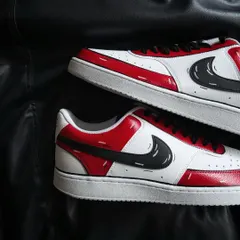A top-down view of the red cartoon custom sneakers.