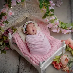 The tiniest yawn in a bed of flowers. Capturing these sleepy, candid moments is just as important as the posed shots. It's all part of their story.