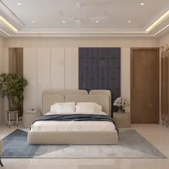 We create master bedrooms that feel like a personal sanctuary. This spacious room balances a neutral color palette with a bold blue upholstered headboard, a dedicated work-from-home corner, and elegant gold-accented wardrobes for a touch of luxury.