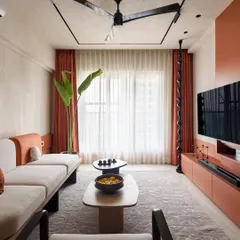 For our project 'A Den', we blended modern design with the client's South Indian heritage. This living room uses an earthy terracotta and neutral palette, with custom furniture and a large banana plant to bring nature indoors. It shows our ability to create a home that feels both contemporary and deeply personal.