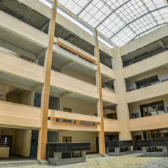 A view from the ground floor of the atrium, looking up at the balconies of the upper floors. This open, vertical space promotes visual connectivity between different levels and enhances natural ventilation.