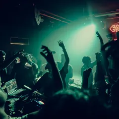 The crowd with their hands up at a Beats & Banter event. When the beat drops, the energy in the room is everything.