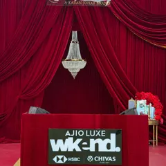 We believe an event's first impression is everything. This grand entrance we designed for the Ajio Luxe WKND event used rich red velvet drapery and a classic chandelier to create a dramatic and luxurious welcome for a high-fashion evening.