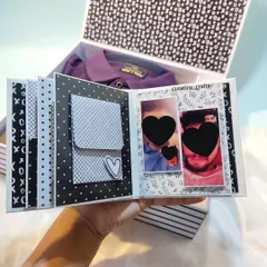 This hamper includes a mini scrapbook and a stylish purple shirt, all in one box.